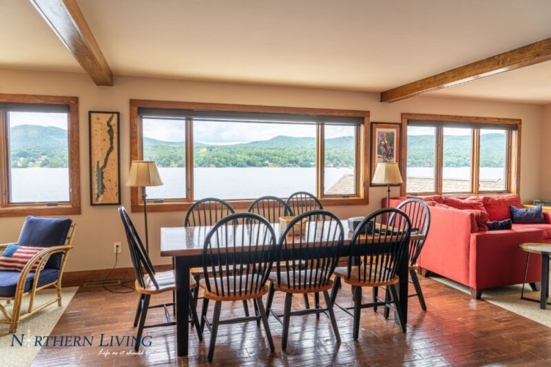 dining table facing windows looking out to lake george