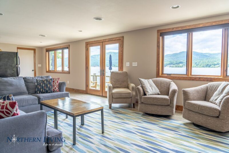 Sitting area with windows overlooking the lake and mountains at French Mountain Cove vacation home rental