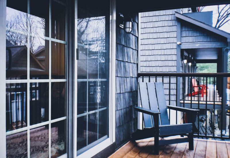 deck with sliding glass doors and an Adirondack chair