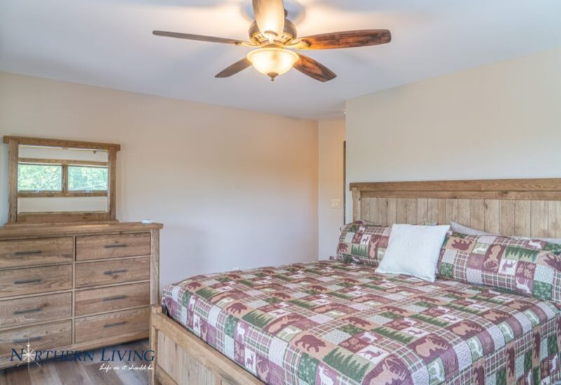 Bed, dresser and ceiling fan