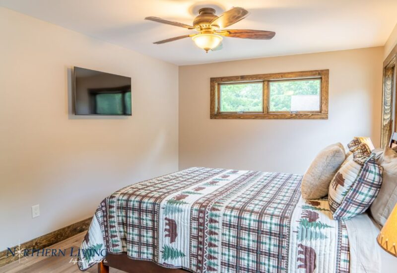 bed with wall-mounted tv