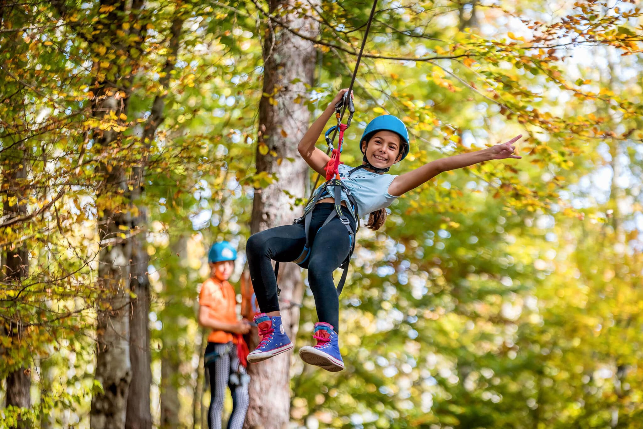 Girl on zipline in aerial adventure park