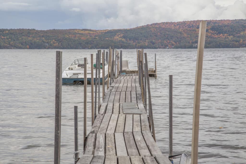 wooden dock with boat on lake george